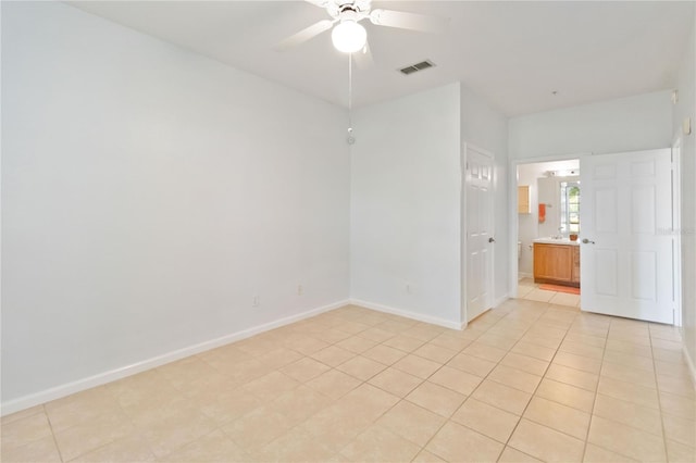 unfurnished room featuring ceiling fan and light tile patterned floors