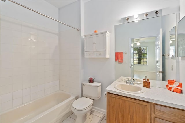 full bathroom featuring ceiling fan, tile patterned floors, toilet, vanity, and tiled shower / bath