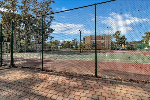 view of tennis court with fence