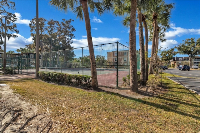 view of tennis court featuring fence