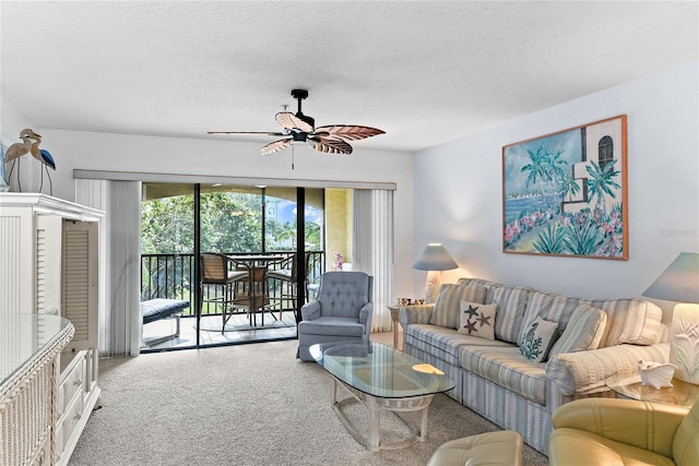 carpeted living room with a textured ceiling and ceiling fan