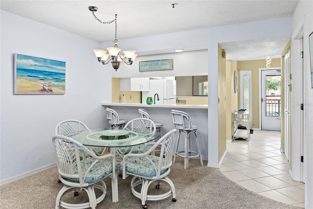 dining room featuring light colored carpet, a textured ceiling, and an inviting chandelier