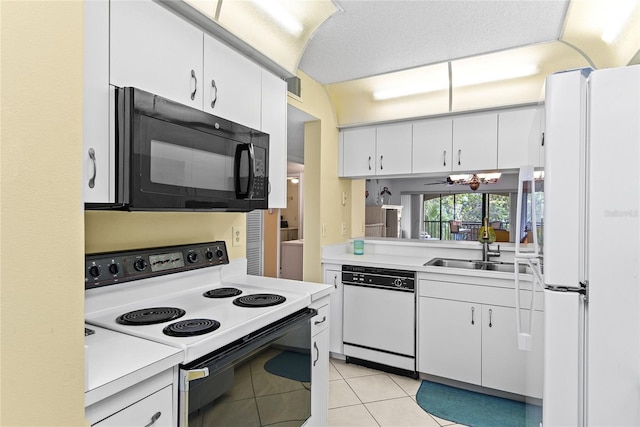 kitchen featuring white cabinetry, ceiling fan, sink, white appliances, and light tile patterned floors