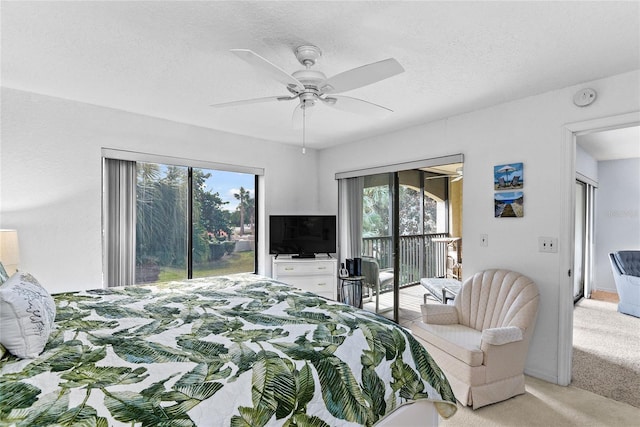 carpeted bedroom featuring ceiling fan, access to exterior, and a textured ceiling