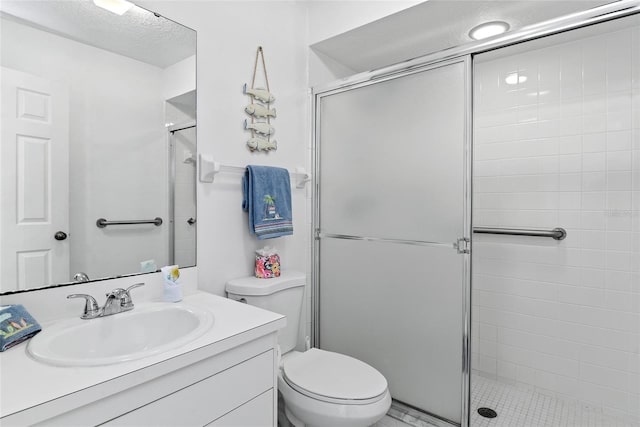 bathroom featuring vanity, toilet, and walk in shower