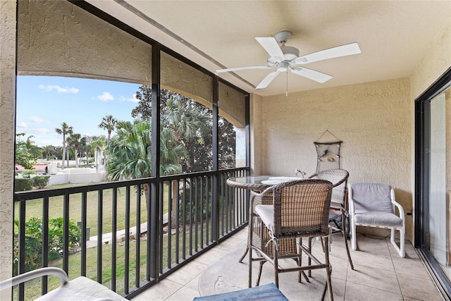 sunroom / solarium featuring ceiling fan