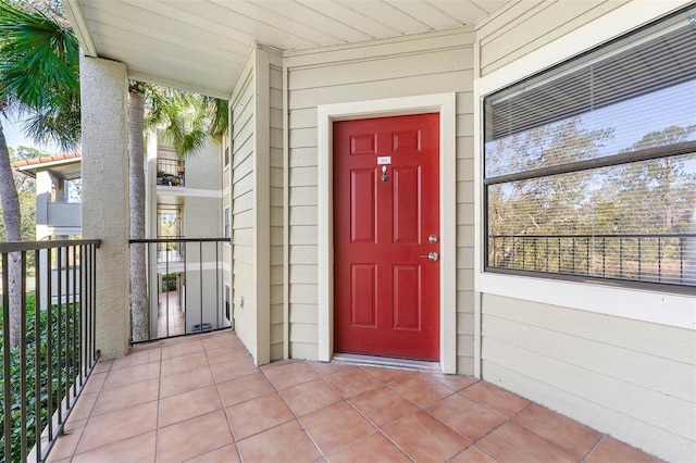 view of exterior entry featuring a balcony