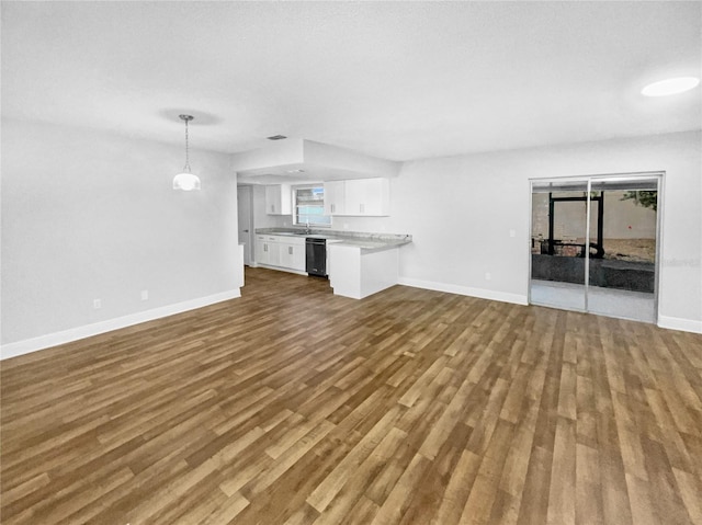 unfurnished living room with sink and light hardwood / wood-style flooring