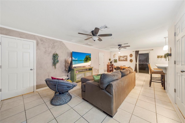 tiled living room featuring crown molding and ceiling fan