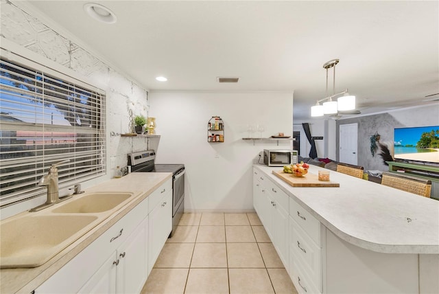 kitchen with crown molding, stainless steel appliances, decorative light fixtures, and white cabinets