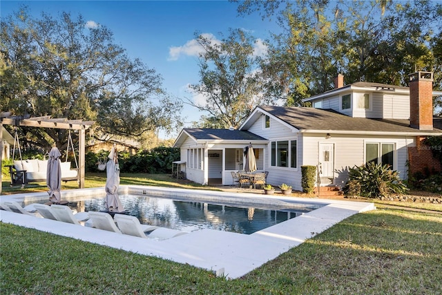 rear view of house featuring a pergola, a fenced in pool, a yard, and a patio