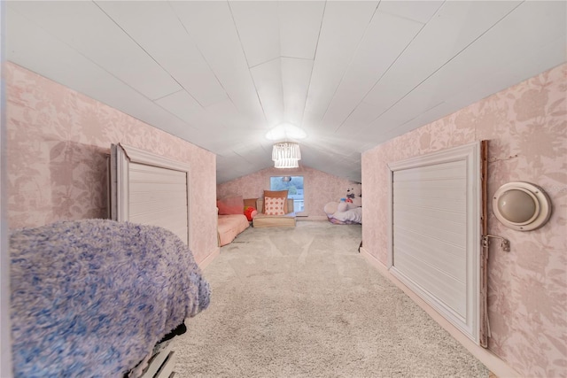 bedroom with lofted ceiling and carpet