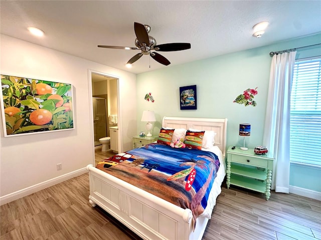 bedroom with hardwood / wood-style floors, ensuite bath, and ceiling fan