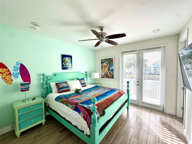 bedroom featuring access to exterior, a textured ceiling, hardwood / wood-style flooring, and ceiling fan