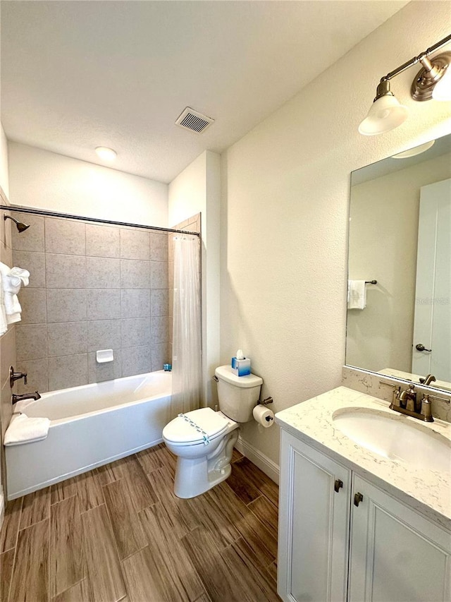 full bathroom featuring shower / bath combination with curtain, toilet, and vanity