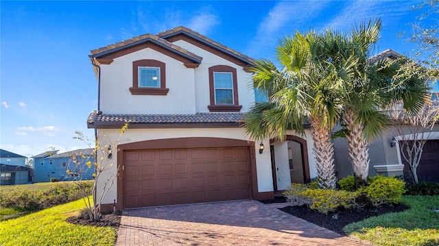 mediterranean / spanish-style home with a garage