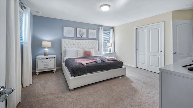 bedroom featuring a closet and light colored carpet