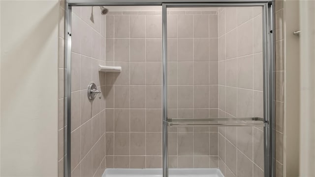 bathroom with a shower with door