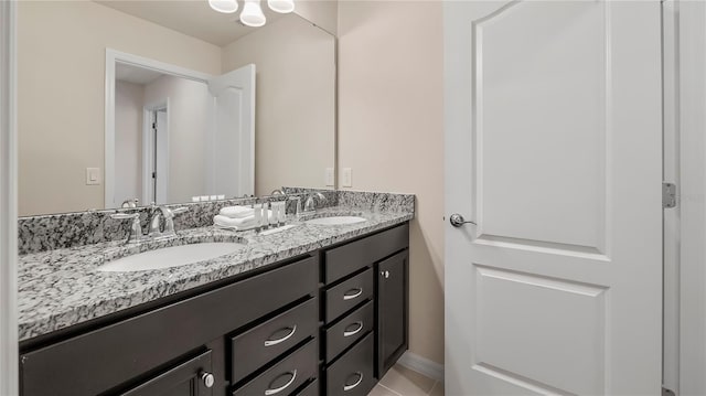 bathroom with tile patterned floors and vanity