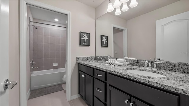 full bathroom featuring tile patterned floors, vanity, toilet, and tiled shower / bath