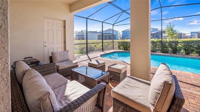 view of swimming pool featuring outdoor lounge area, a lanai, and a patio