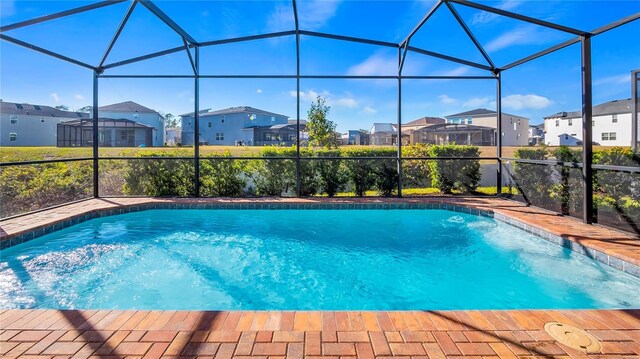 view of swimming pool with a lanai