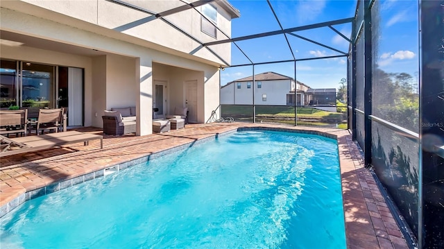 view of swimming pool with a lanai, an outdoor hangout area, and a patio