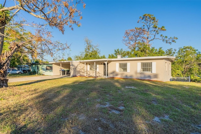 single story home with a carport and a front lawn