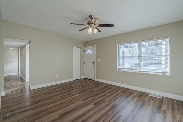 foyer entrance featuring ceiling fan and dark wood-type flooring