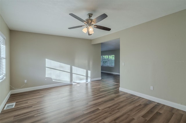 unfurnished room featuring ceiling fan and dark hardwood / wood-style flooring