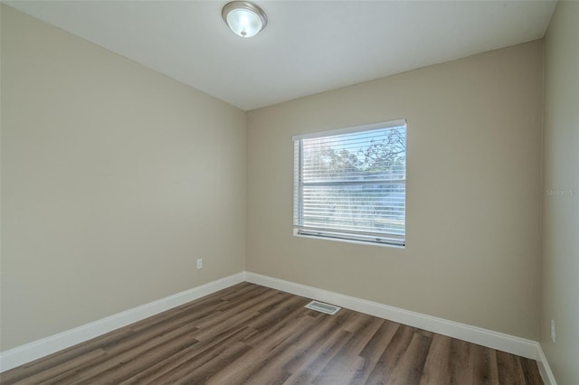 empty room featuring dark hardwood / wood-style flooring