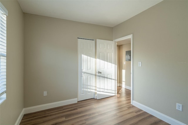 spare room with wood-type flooring