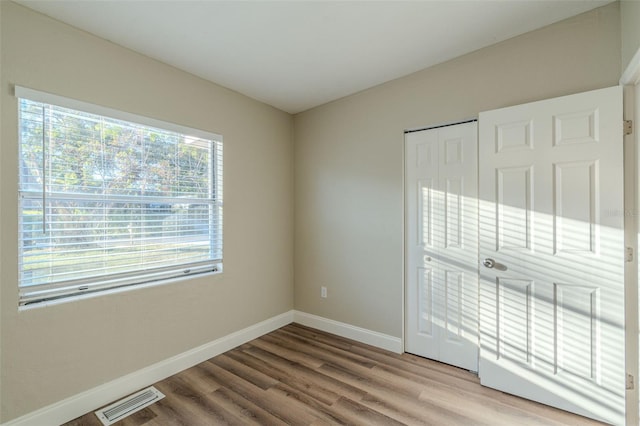 spare room featuring hardwood / wood-style flooring