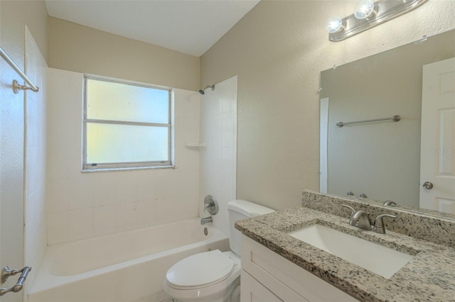 full bathroom with vanity, tiled shower / bath combo, and toilet