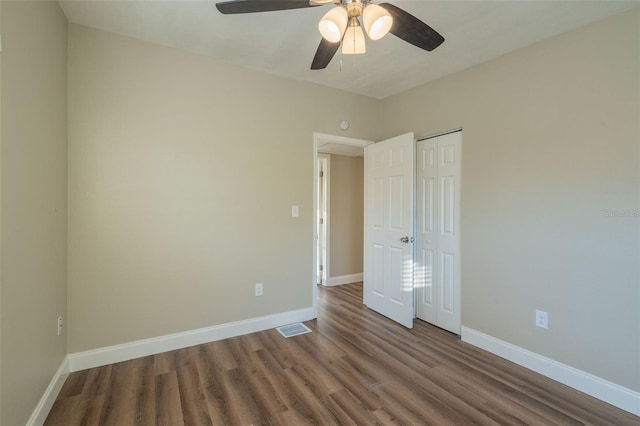 unfurnished bedroom with wood-type flooring, a closet, and ceiling fan