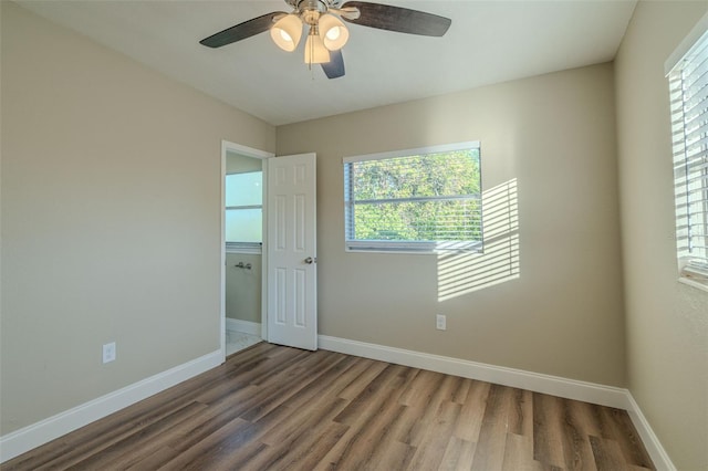 spare room featuring a wealth of natural light and hardwood / wood-style floors