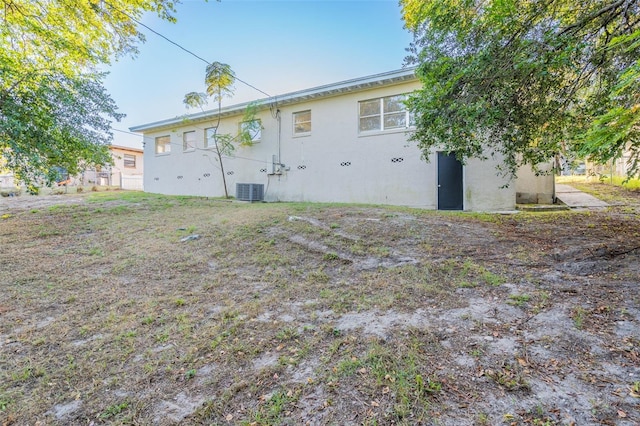 rear view of property featuring central AC