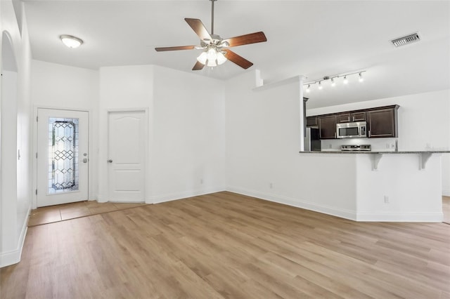 unfurnished living room featuring light hardwood / wood-style floors and ceiling fan