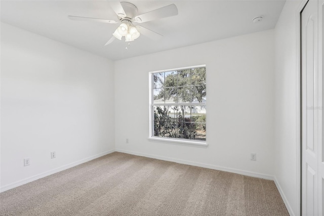 empty room featuring carpet floors and ceiling fan