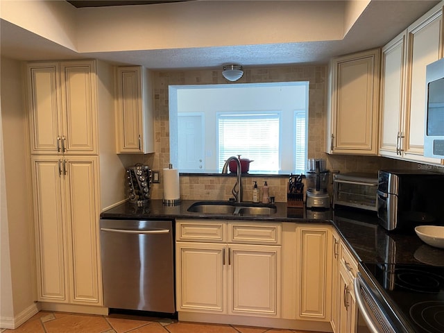 kitchen featuring backsplash, sink, stainless steel dishwasher, light tile patterned floors, and a textured ceiling