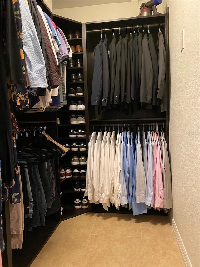 spacious closet featuring light tile patterned floors