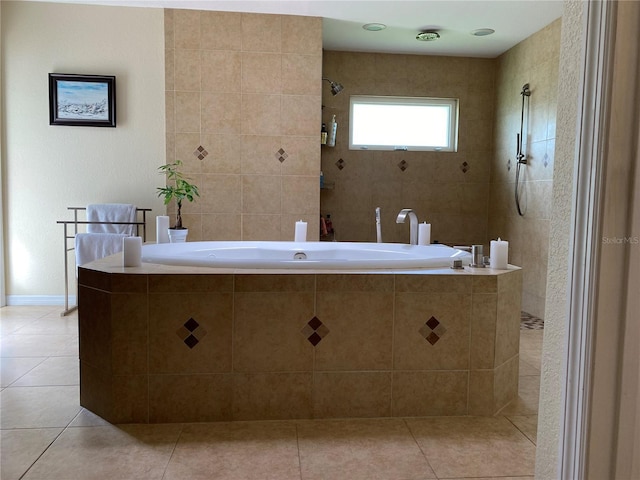 bathroom featuring tile patterned flooring and a tile shower