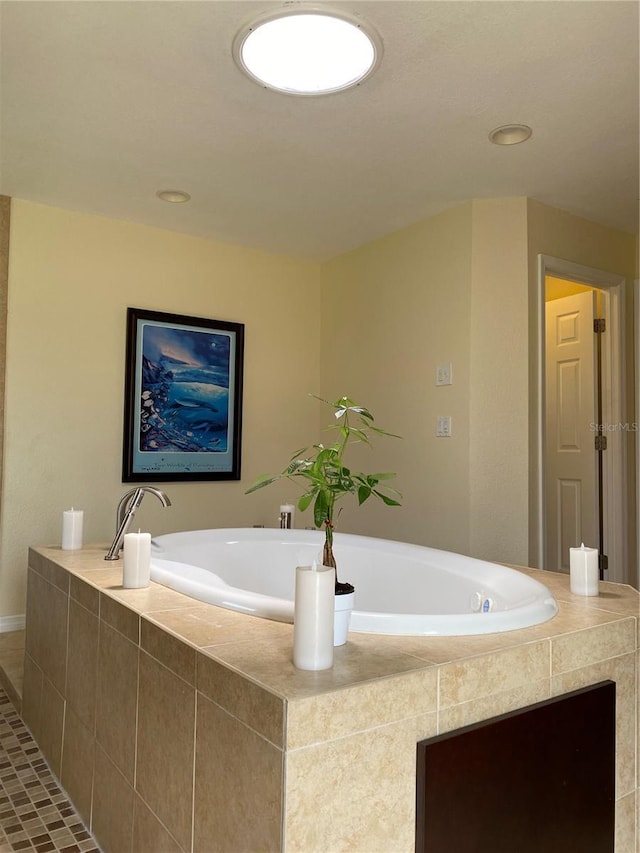 bathroom with tile patterned floors and tiled bath