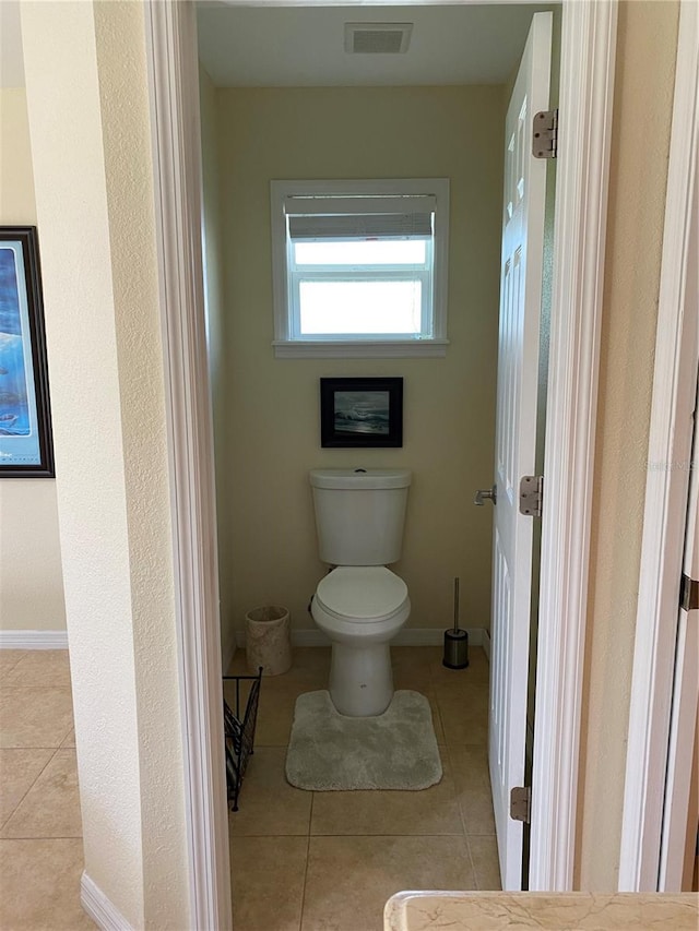 bathroom featuring tile patterned flooring and toilet