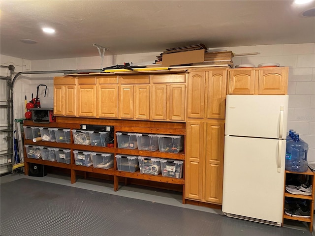 garage featuring white fridge