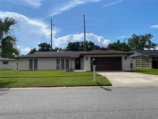 single story home featuring a front lawn and a garage