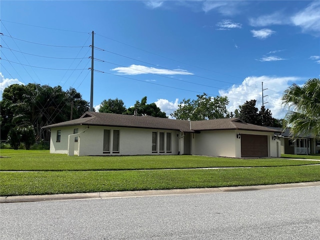 single story home featuring a front lawn and a garage