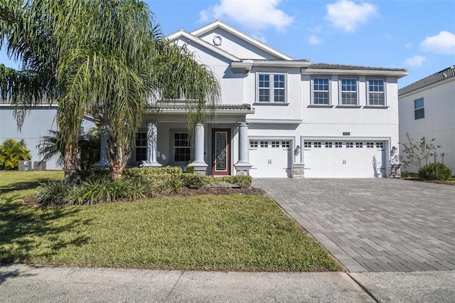 view of front of home with a front yard and a garage