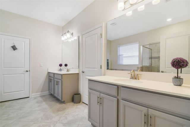 bathroom featuring tile patterned flooring, vanity, and a shower with shower door