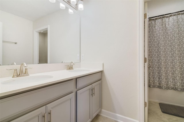 bathroom with a shower with curtain, vanity, and tile patterned floors